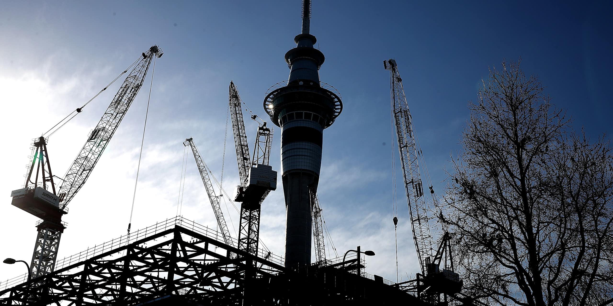Auckland Sky Tower with construction cranes