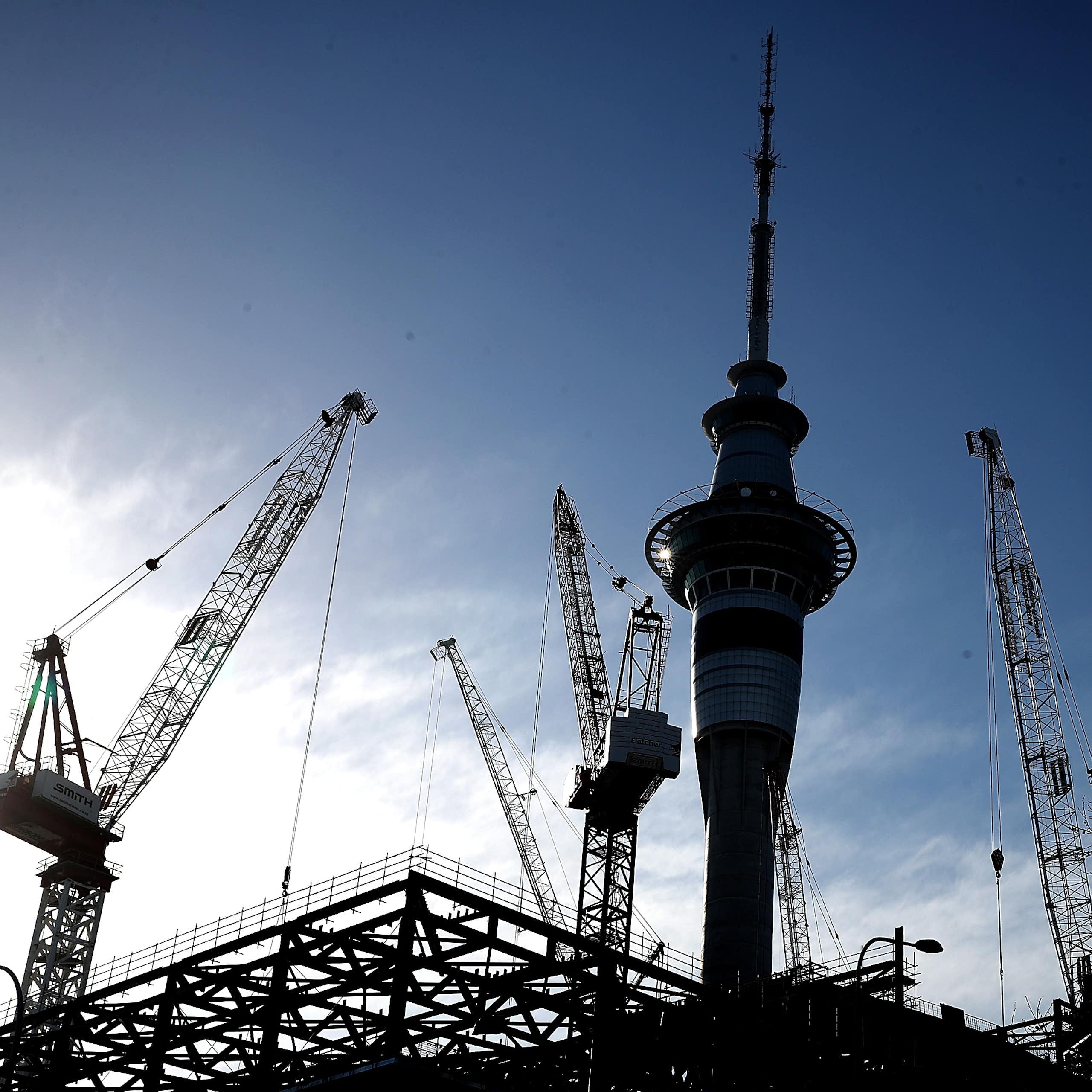 Auckland Sky Tower with construction cranes