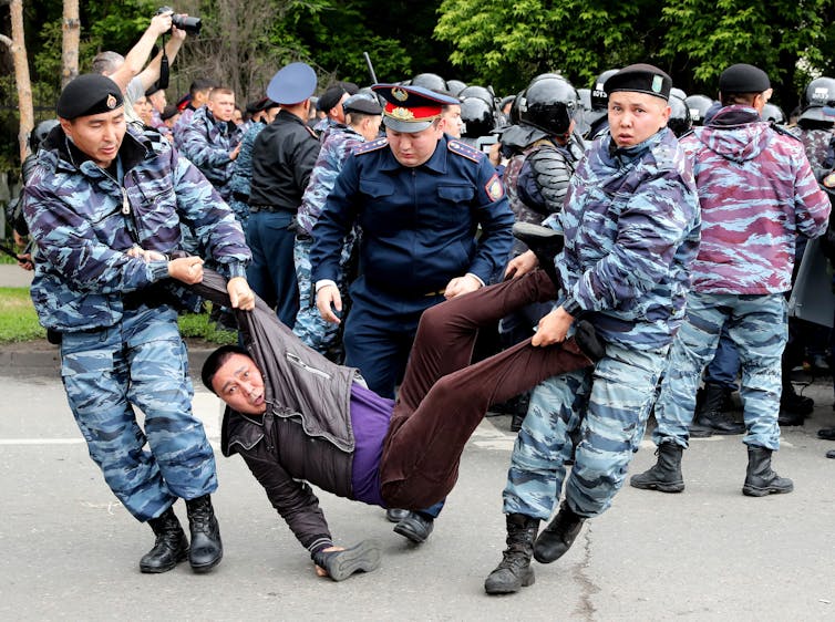 Police arrest a protester in Kazakhstan in 2019.
