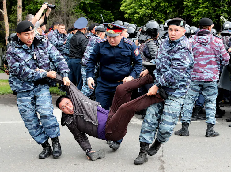 Police arrest a protester in Kazakhstan in 2019.