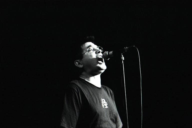 Black and white photo, Albini at a microphone