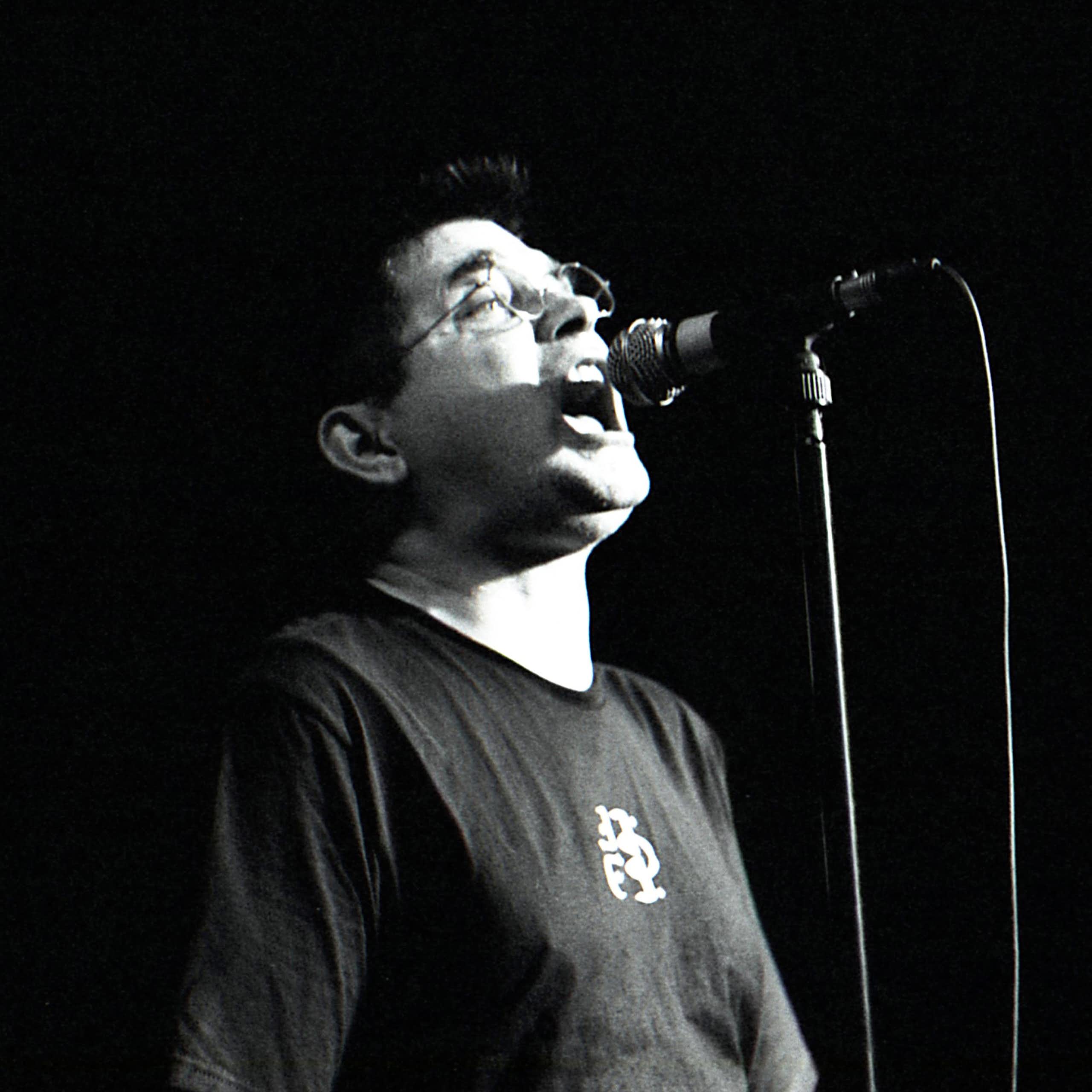 Black and white photo, Albini at a microphone