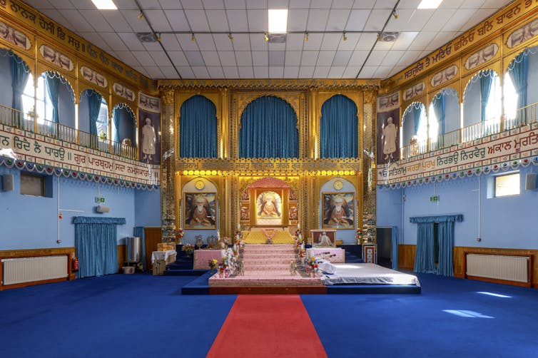 The interior of a cinema converted into a gurdwara.