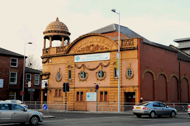 A large cinema building with a poster on the front.