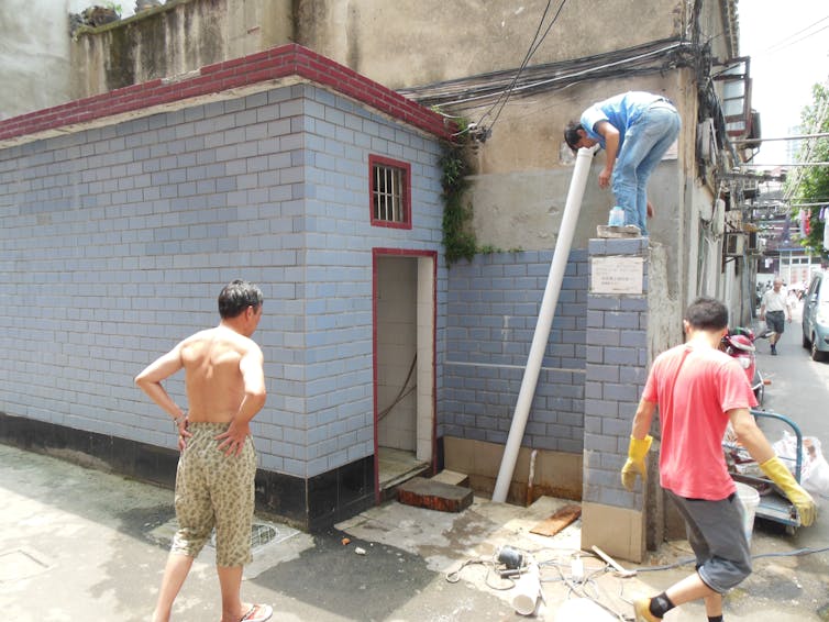 Men work on a small construction project.