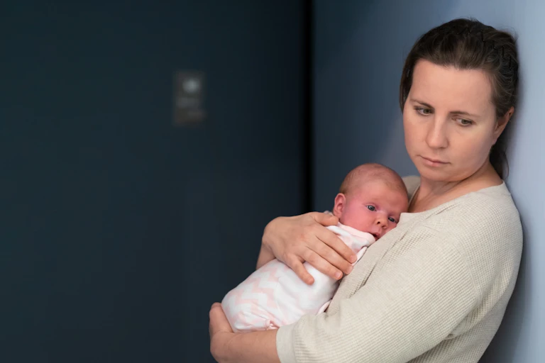 Tired looking woman with a baby