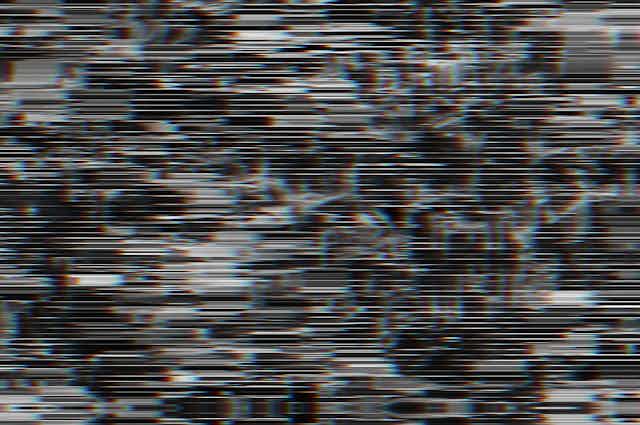 Black and white horizontal lines partially obscuring vague shapes