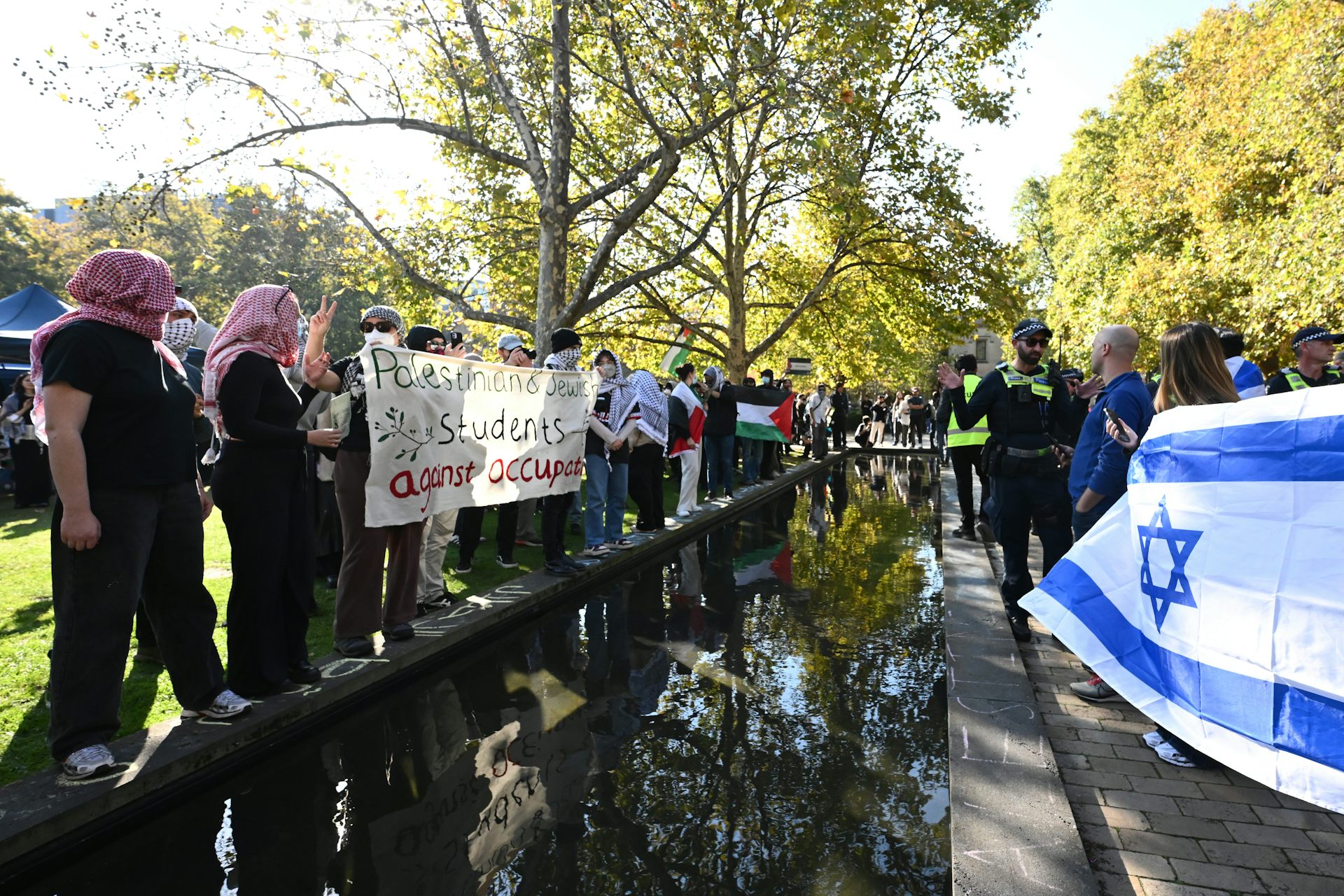 Pro-Israel demonstrators gather opposite a Pro-Palestine encampment.