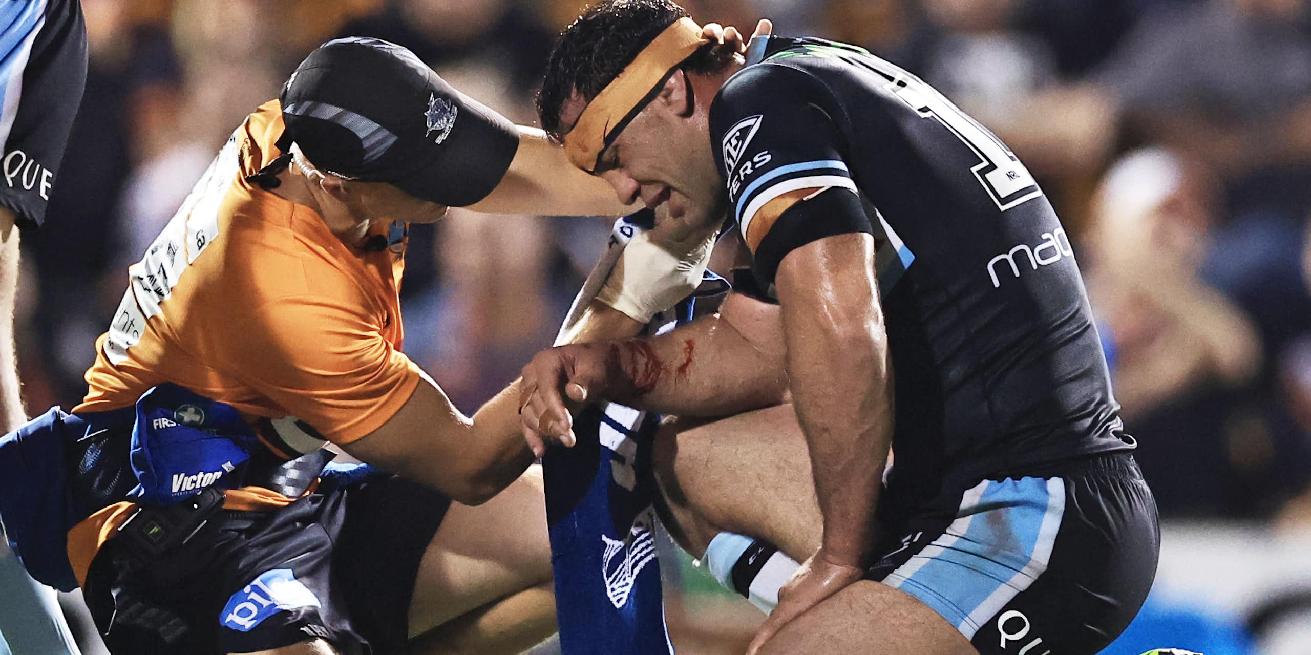 Dale Finucane of the Sharks is treated during a 2024 NRL match