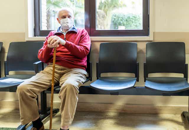 Older man waits in medical clinic