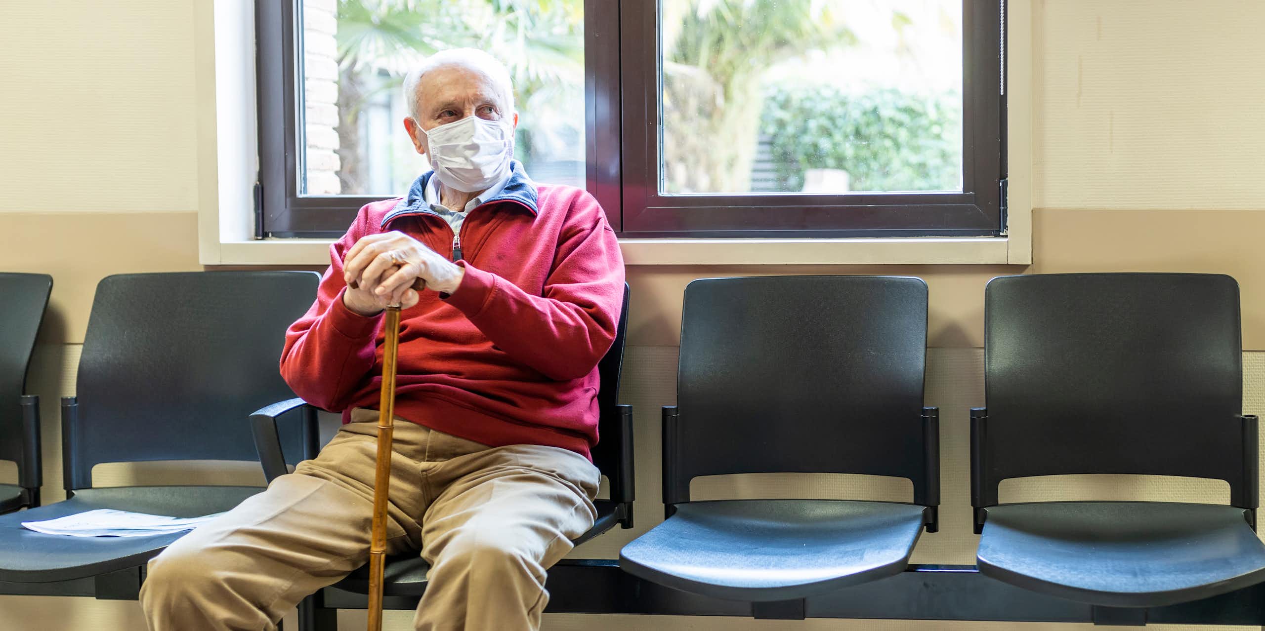 Older man waits in medical clinic