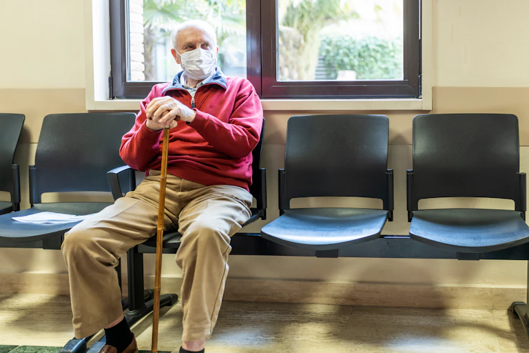 Older man waits in medical clinic