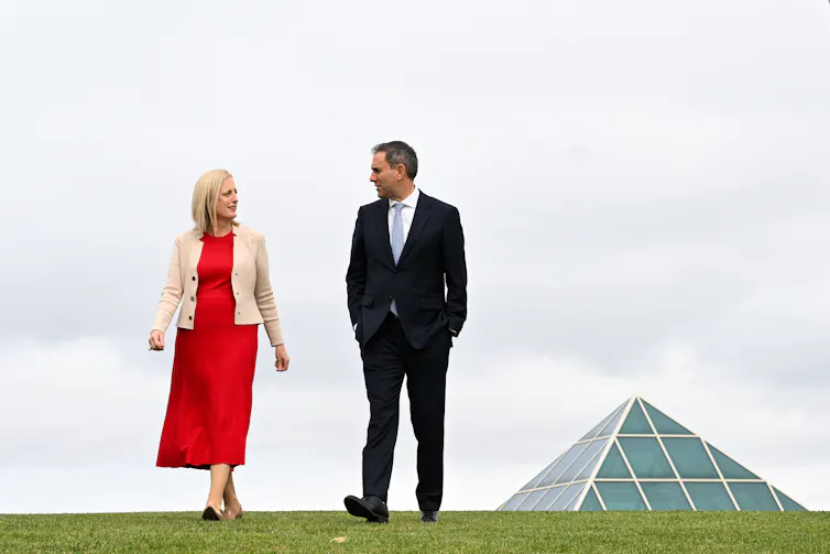 man and woman walking at parliament house