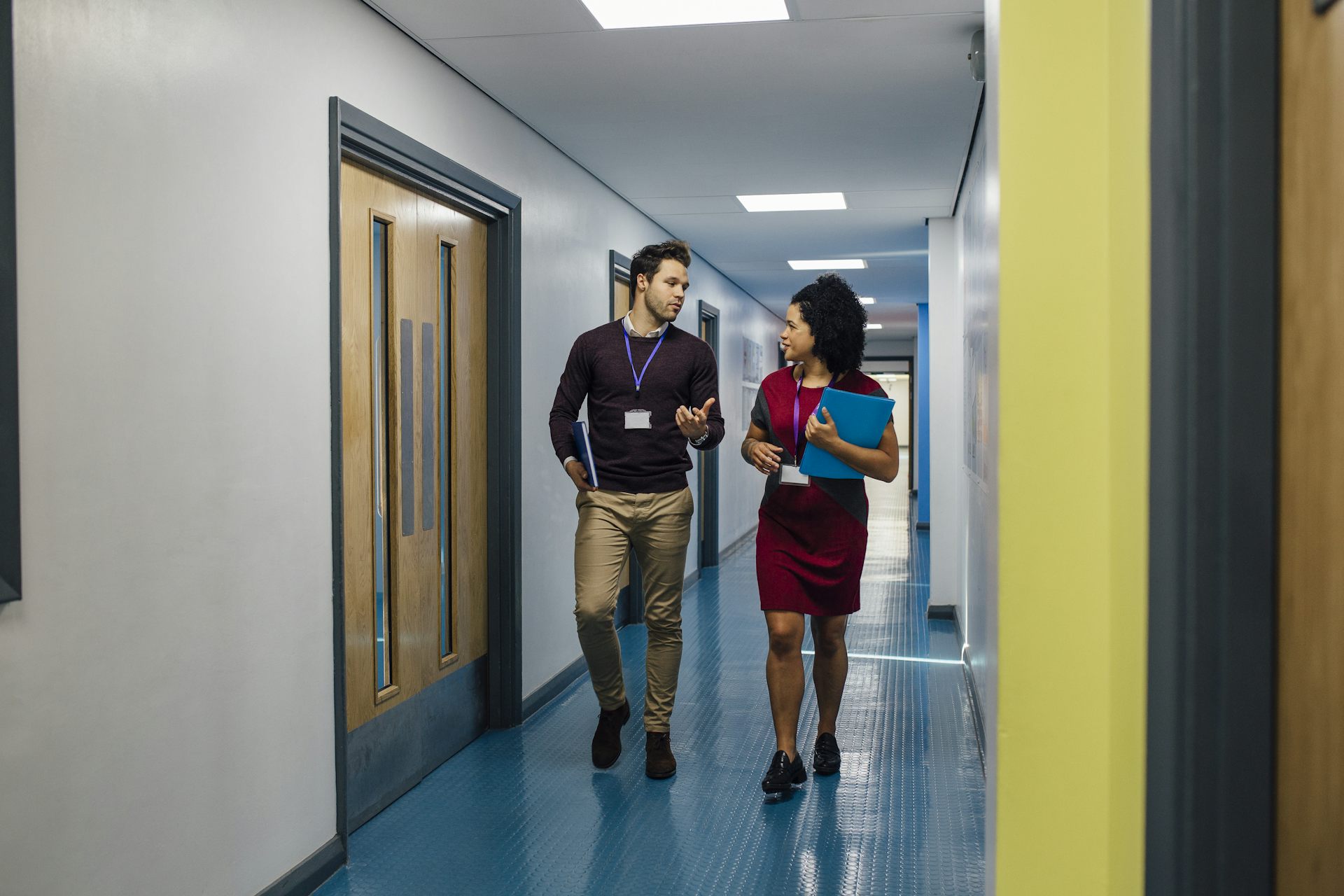 Two teachers walking in corridor