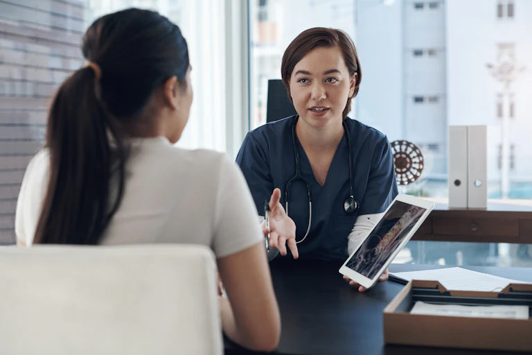 A health-care worker talks you a young female patient.