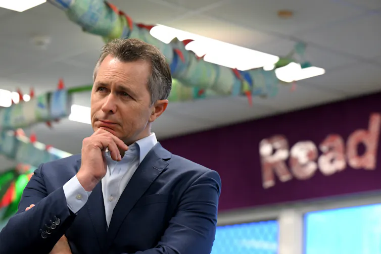 Education minister Jason Clare strikes a thoughtful pose at a media event.