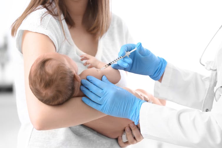 A baby receives a vaccine.