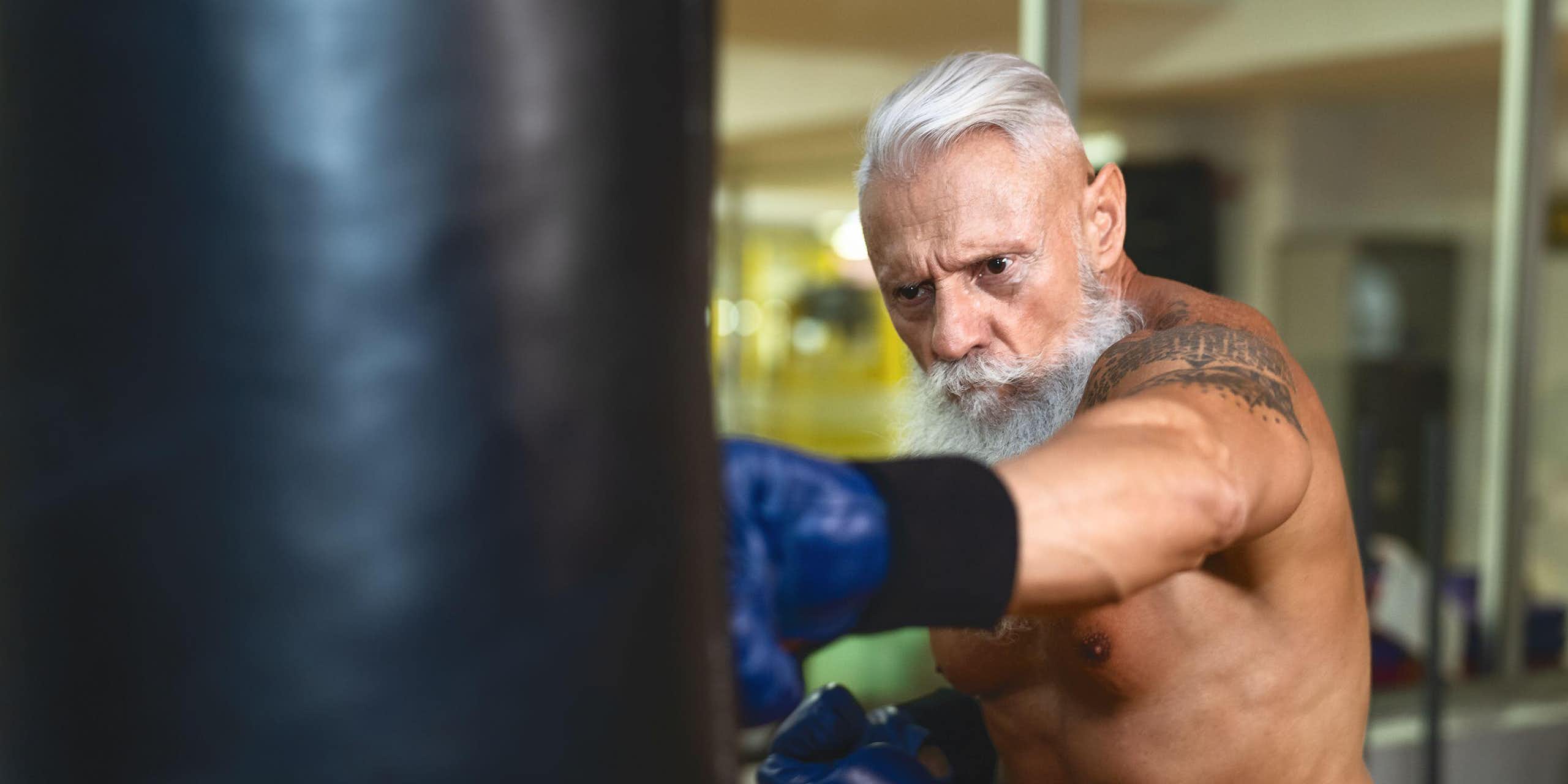Older man punching a heavy bag