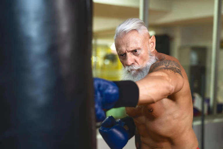 Older man punching a heavy bag