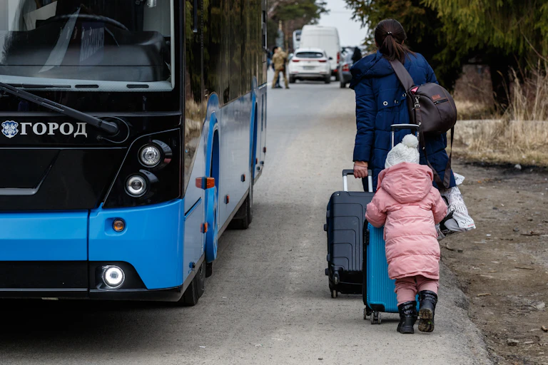 Ukrainian refugee with a child leaves the country at the Slovakian border fleeing Russian aggression against Ukraine, February 2022.