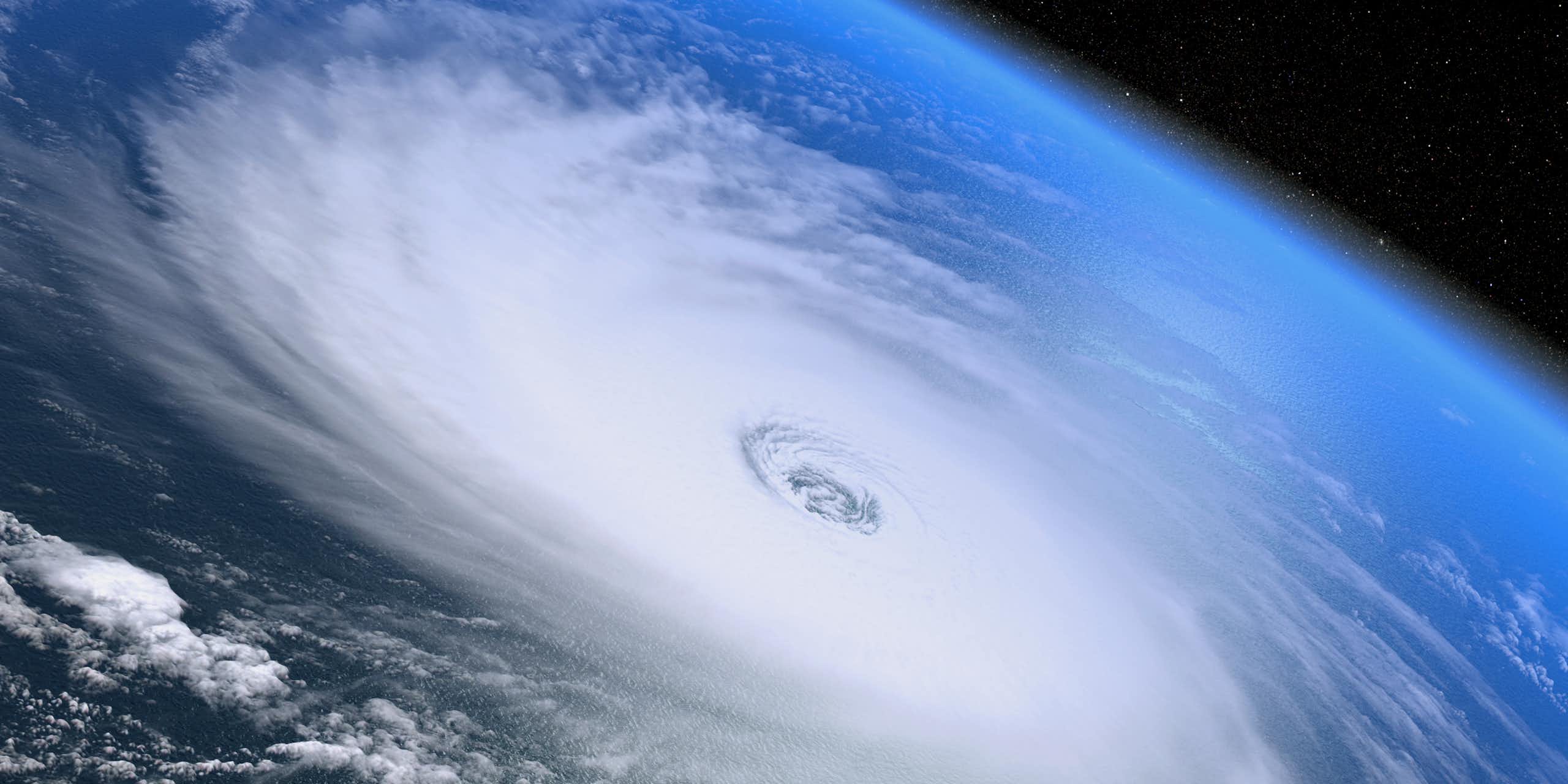 space shot looking down over white hurricane swirls over Earth