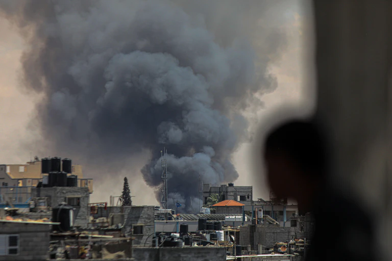 A plume of smoke in a dense urban environment.
