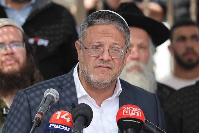 A man in smart clothing delivering a speech.
