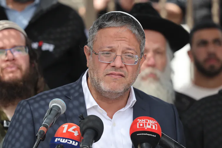 A man in smart clothing delivering a speech.