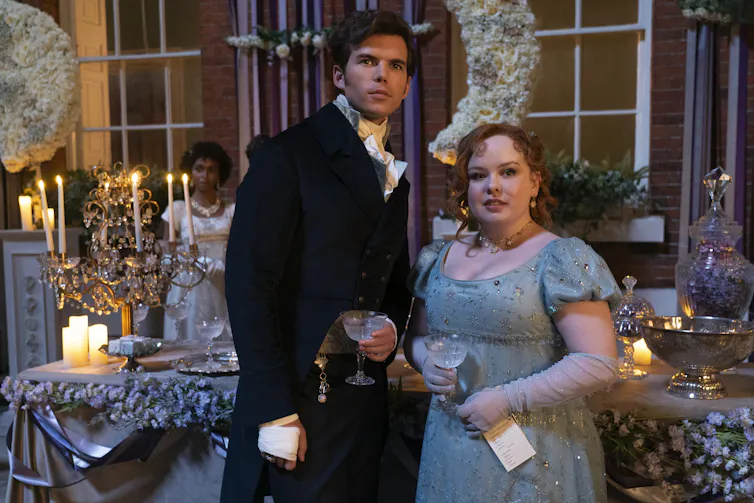 Penelope Featherington and Colin Bridgerton at a ball.