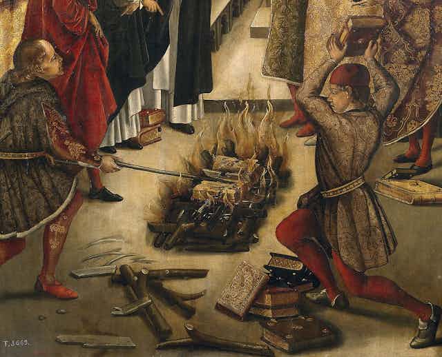 A faded painting shows two men in medieval clothing casting books into a small fire.
