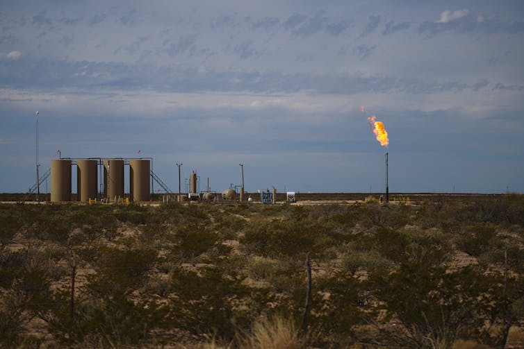 A crude oil storage site with a gas flare