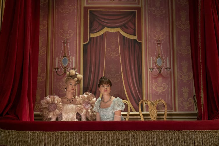 Cressida Cowper and Eloise Bridgerton in a box at the theatre.