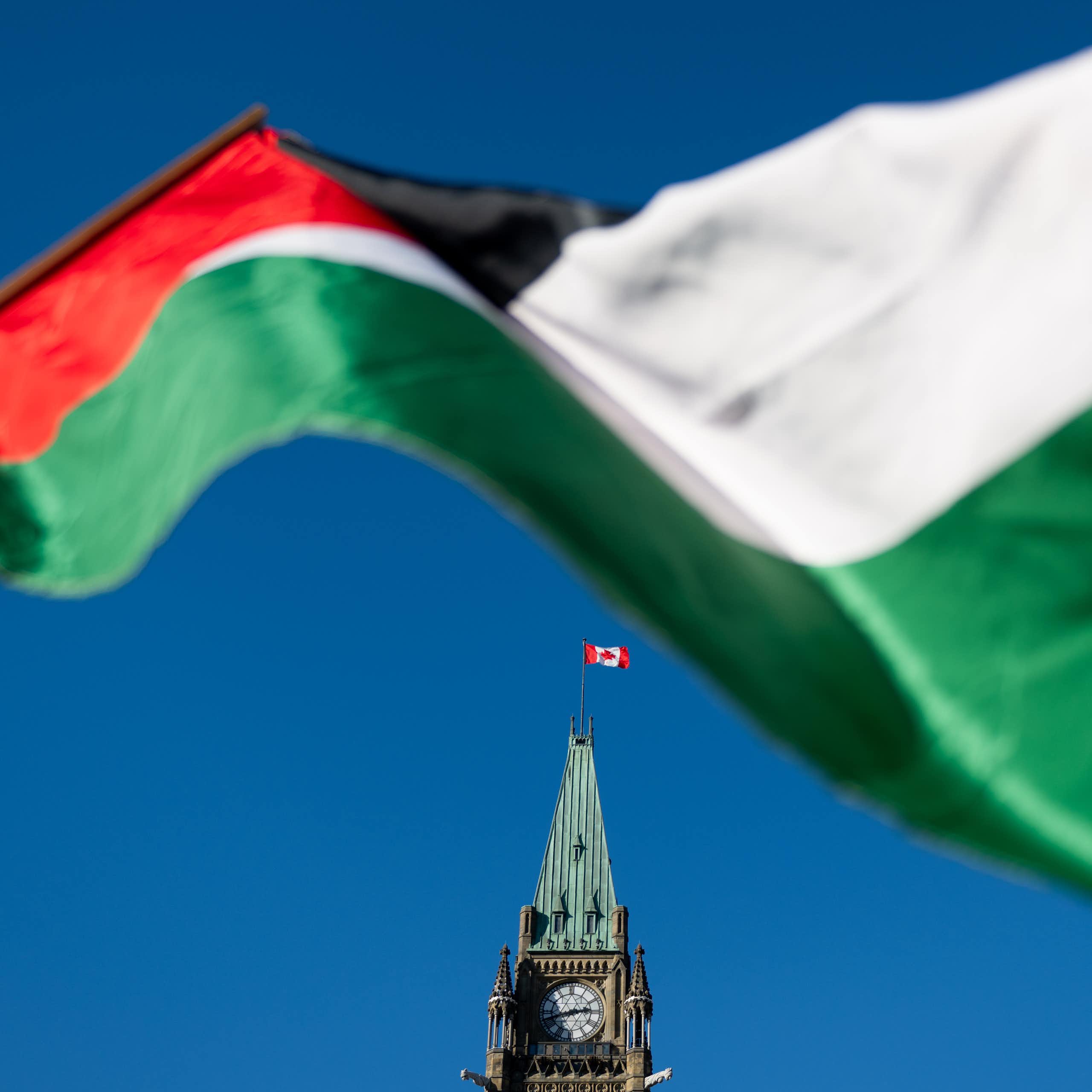 A Palestinian flag flies in front the peace tower at the Canadian parliament
