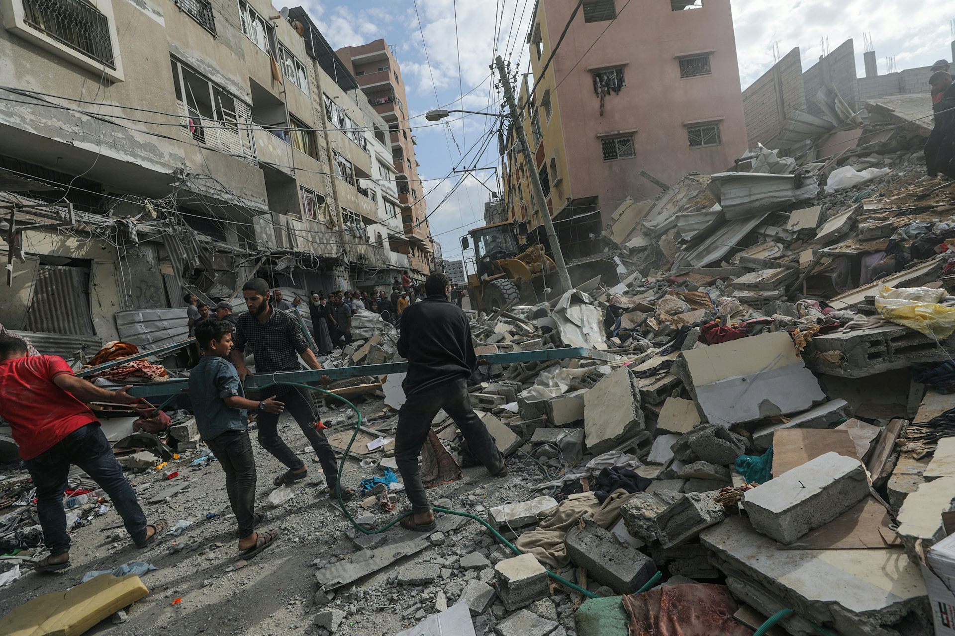 People searching under the debris of a damaged building.