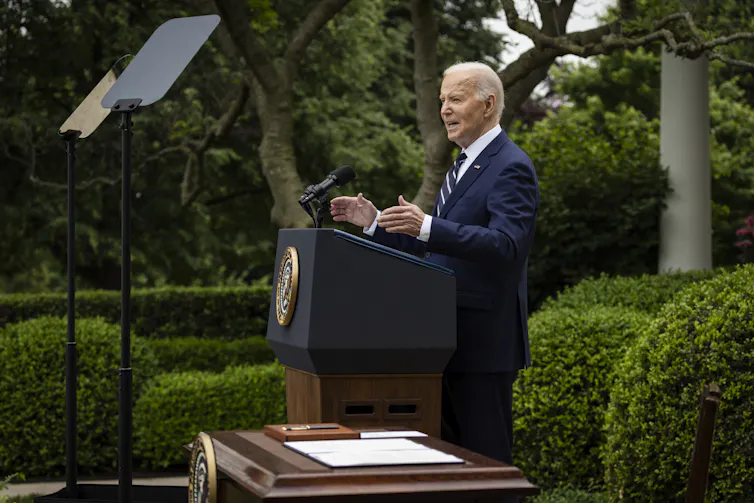 Joe Biden standing in a garden delivering a speech.