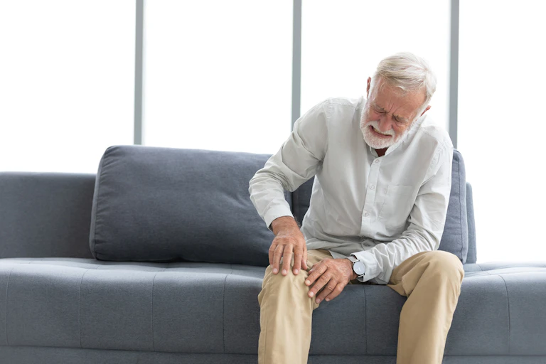 Man holding his knee in agony