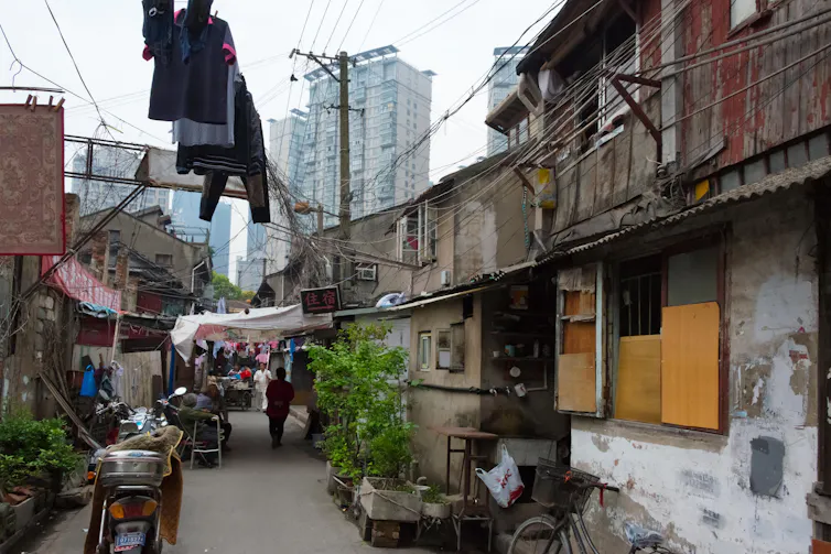 Old houses with high rise blocks in the background.
