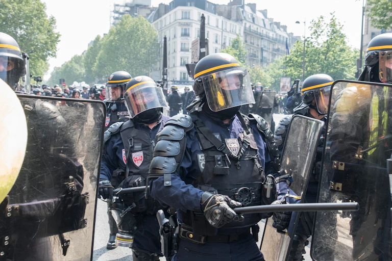 Des policiers français dégagent les manifestants de la chaussée lors d'une manifestation du 1er mai à Paris.