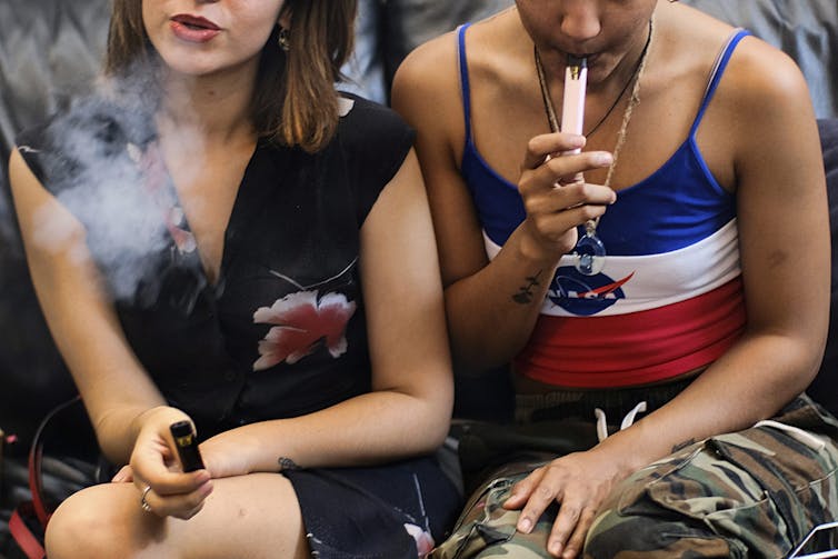 Young people seen vaping.