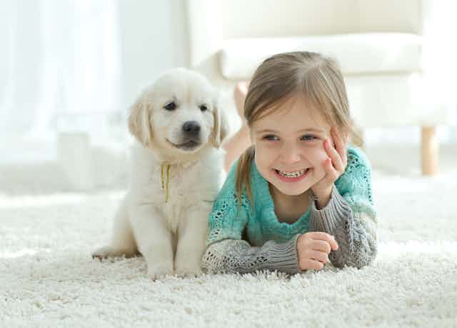 A puppy and a little girl. 