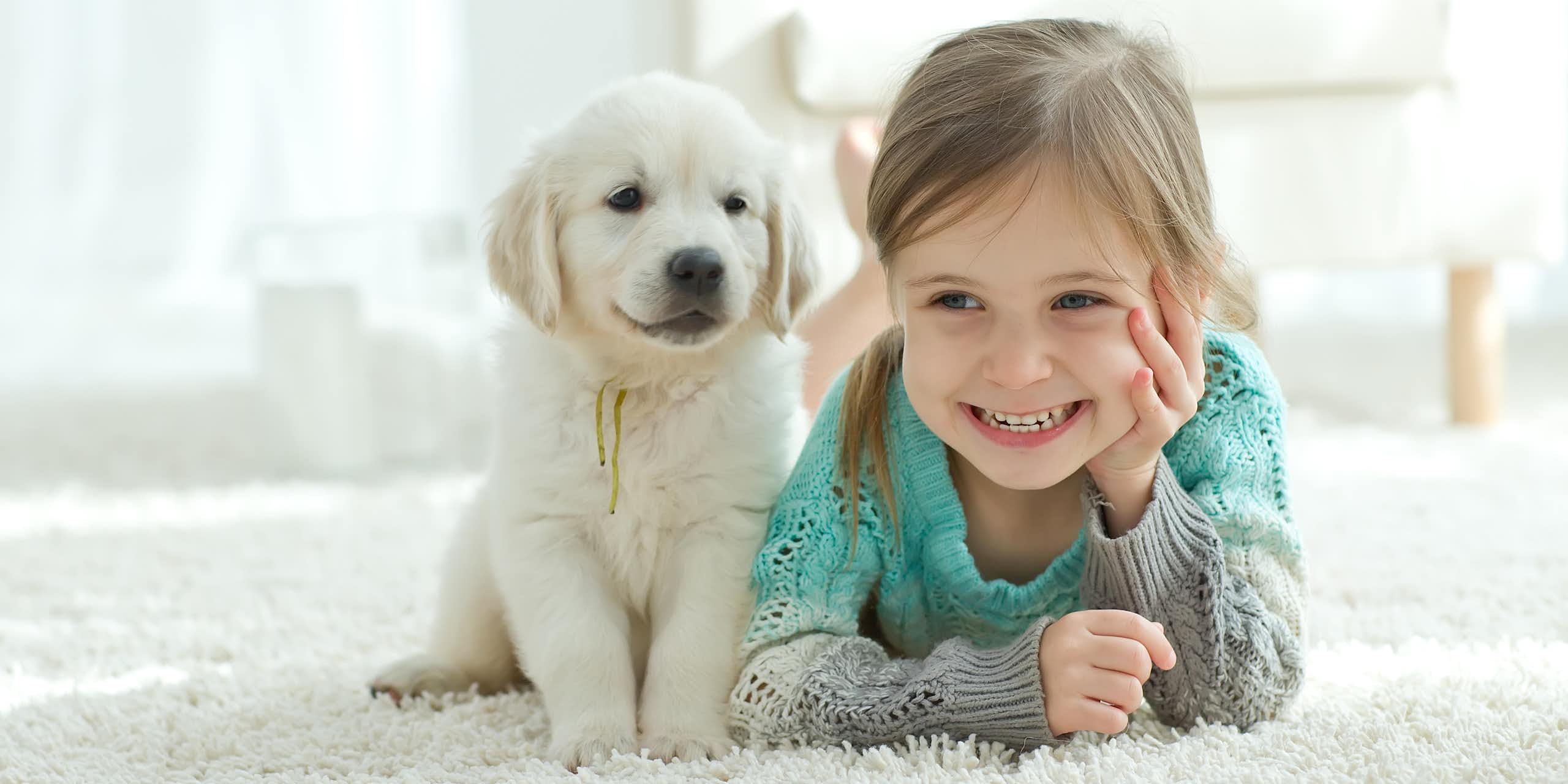 A puppy and a little girl. 