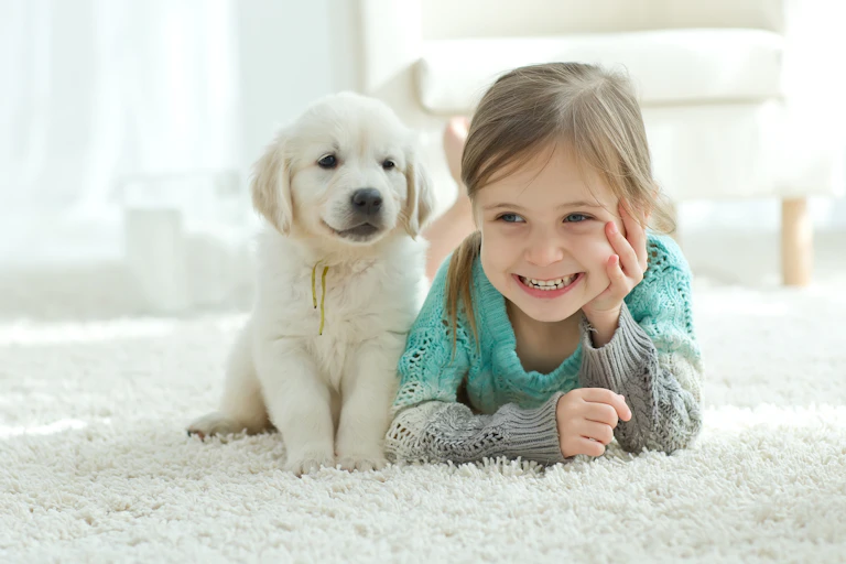 A puppy and a little girl.