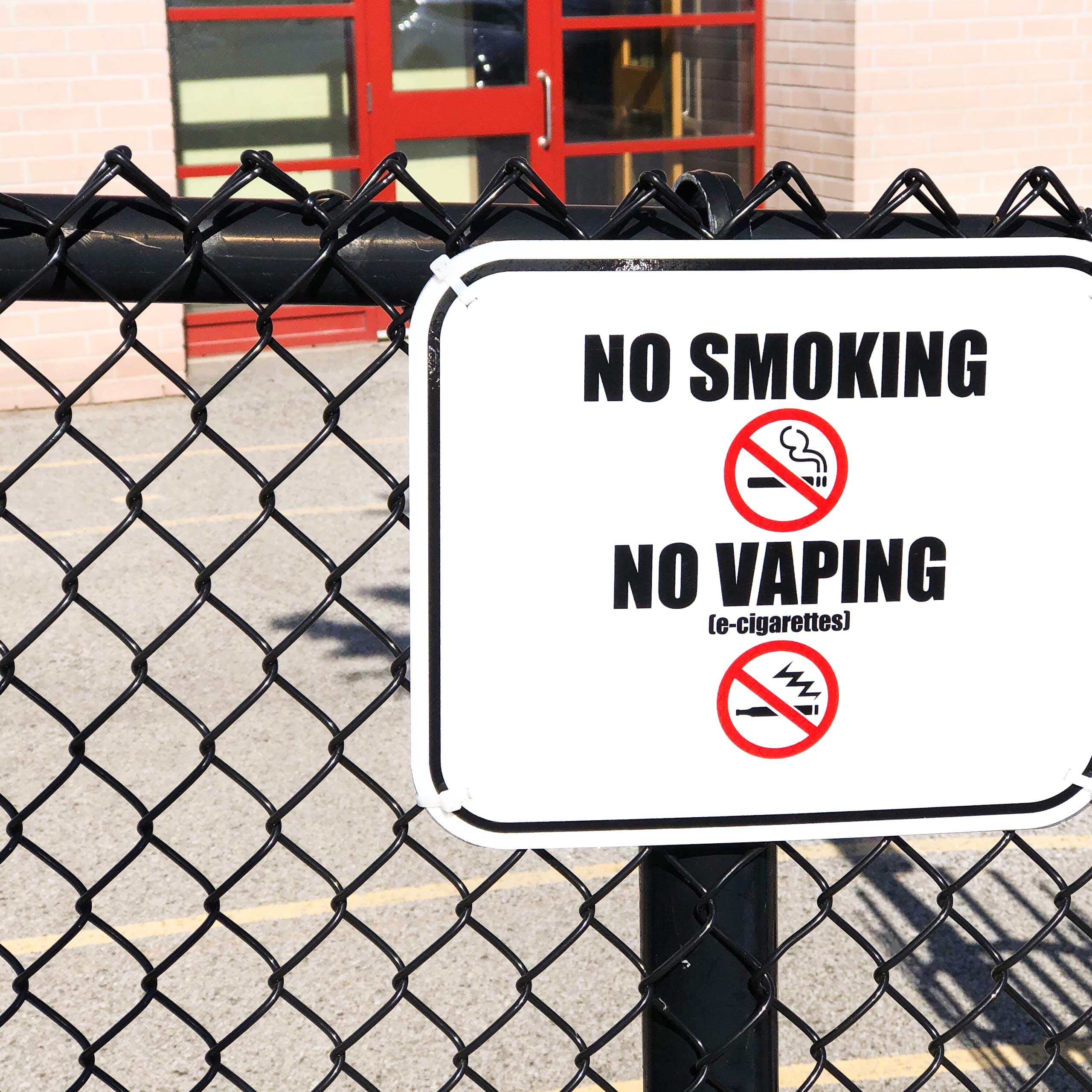 A no smoking, no vaping sign seen on a fence.