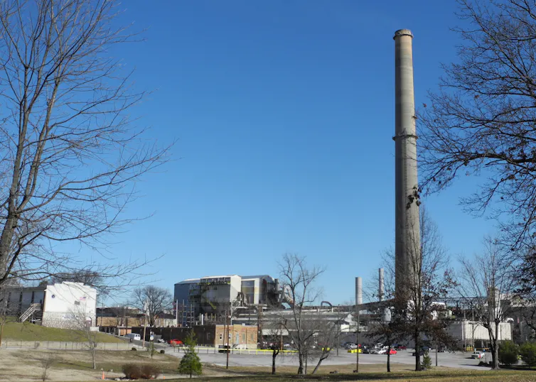 An industrial facility with a towering smokestack