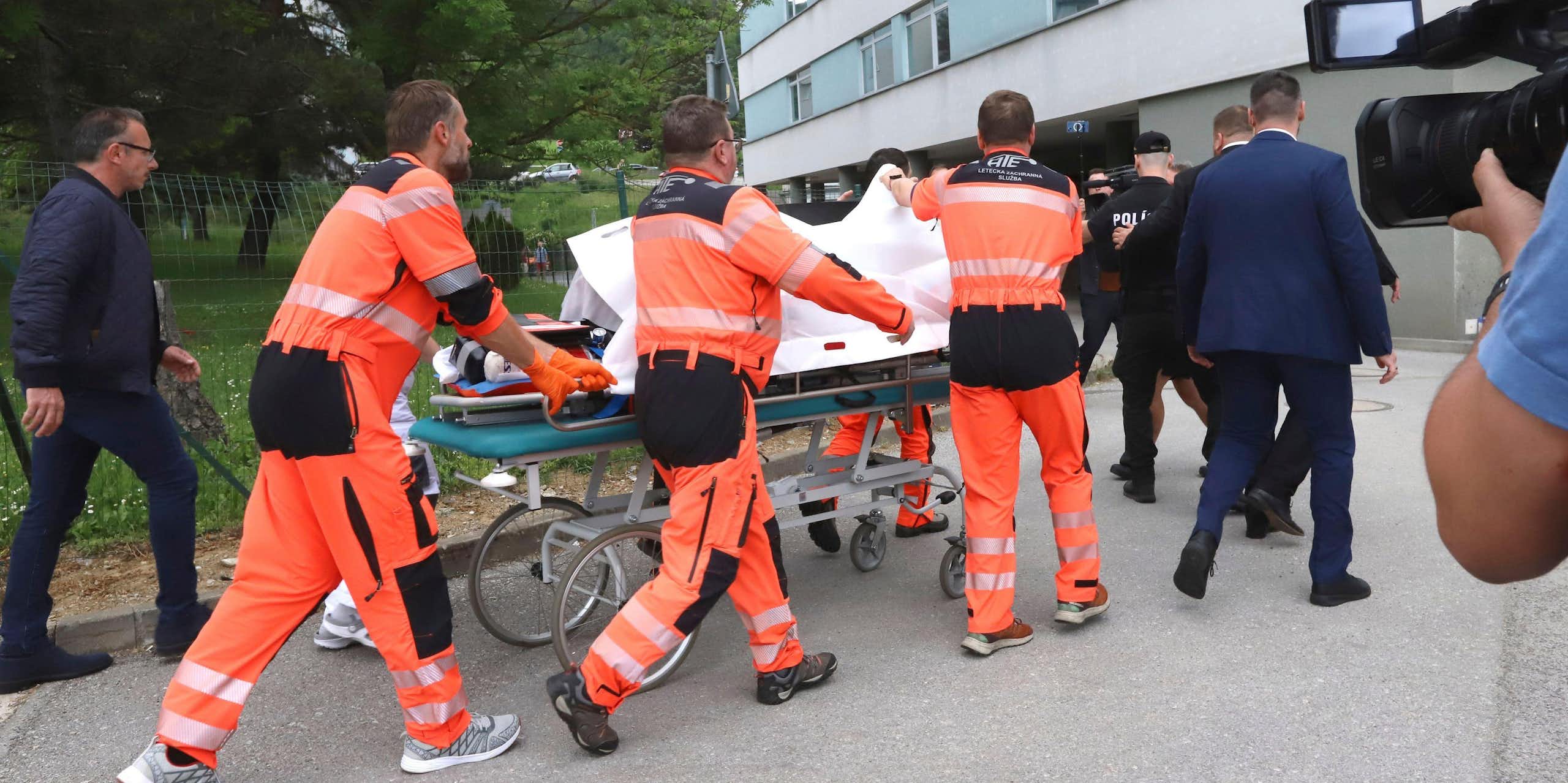 Paramedics wheeling a stretcher into a hospital.