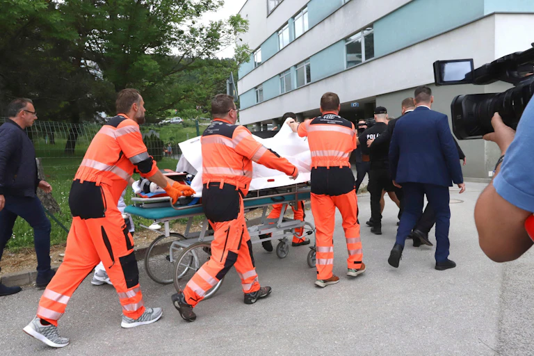 Paramedics wheeling a stretcher into a hospital.