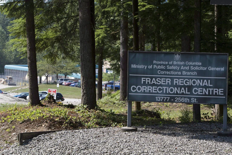 A sign in a wooded area reading" fraser regional correctional centre