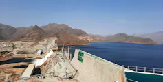 The Grand Ethiopian Renaissance Dam with a giant concrete wall and an expanse of blue, the lake