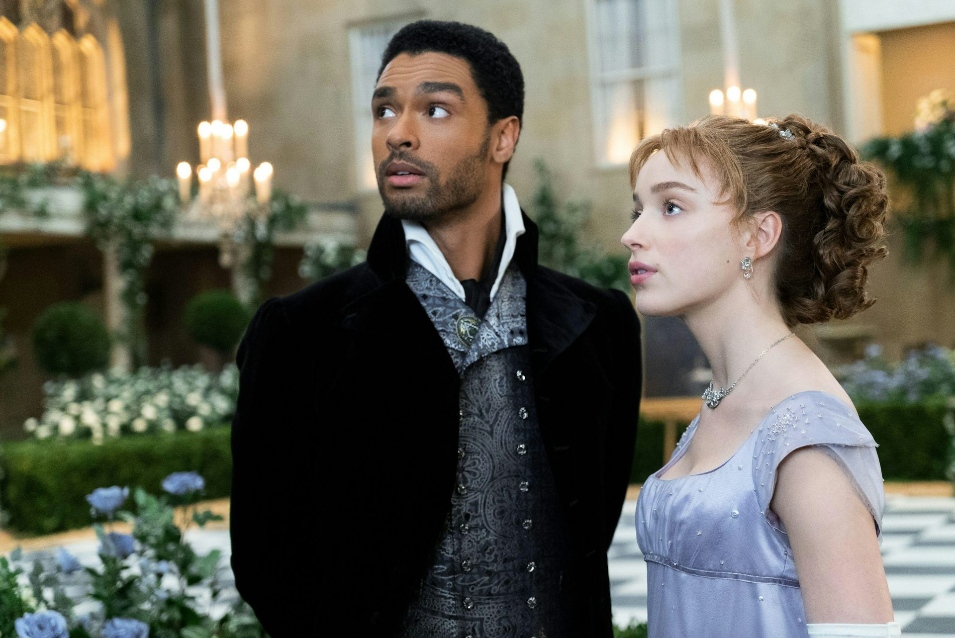 A young regency couple from Bridgerton, the man is black and the woman is white.
