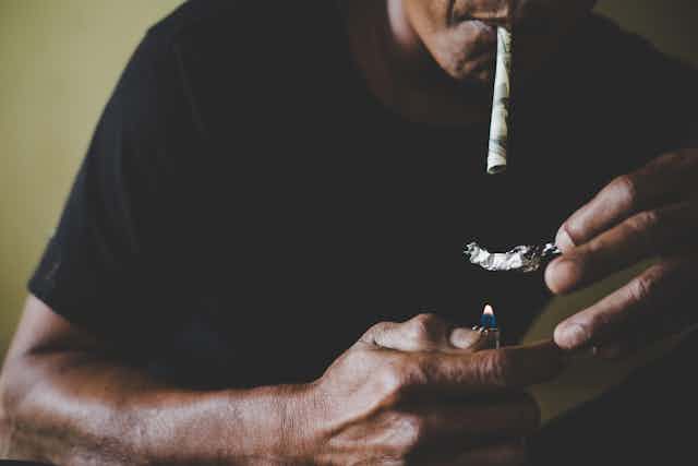 A man smoking heroin